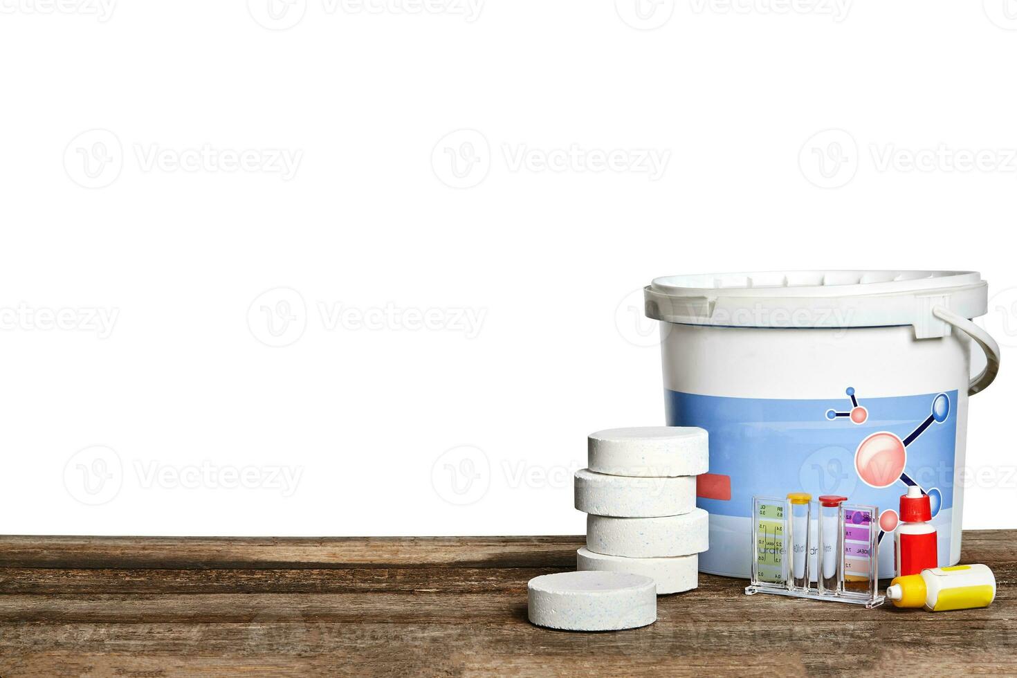 Equipment with chemical cleaning products and tools for the maintenance of the swimming pool on a wooden surface against white background. photo