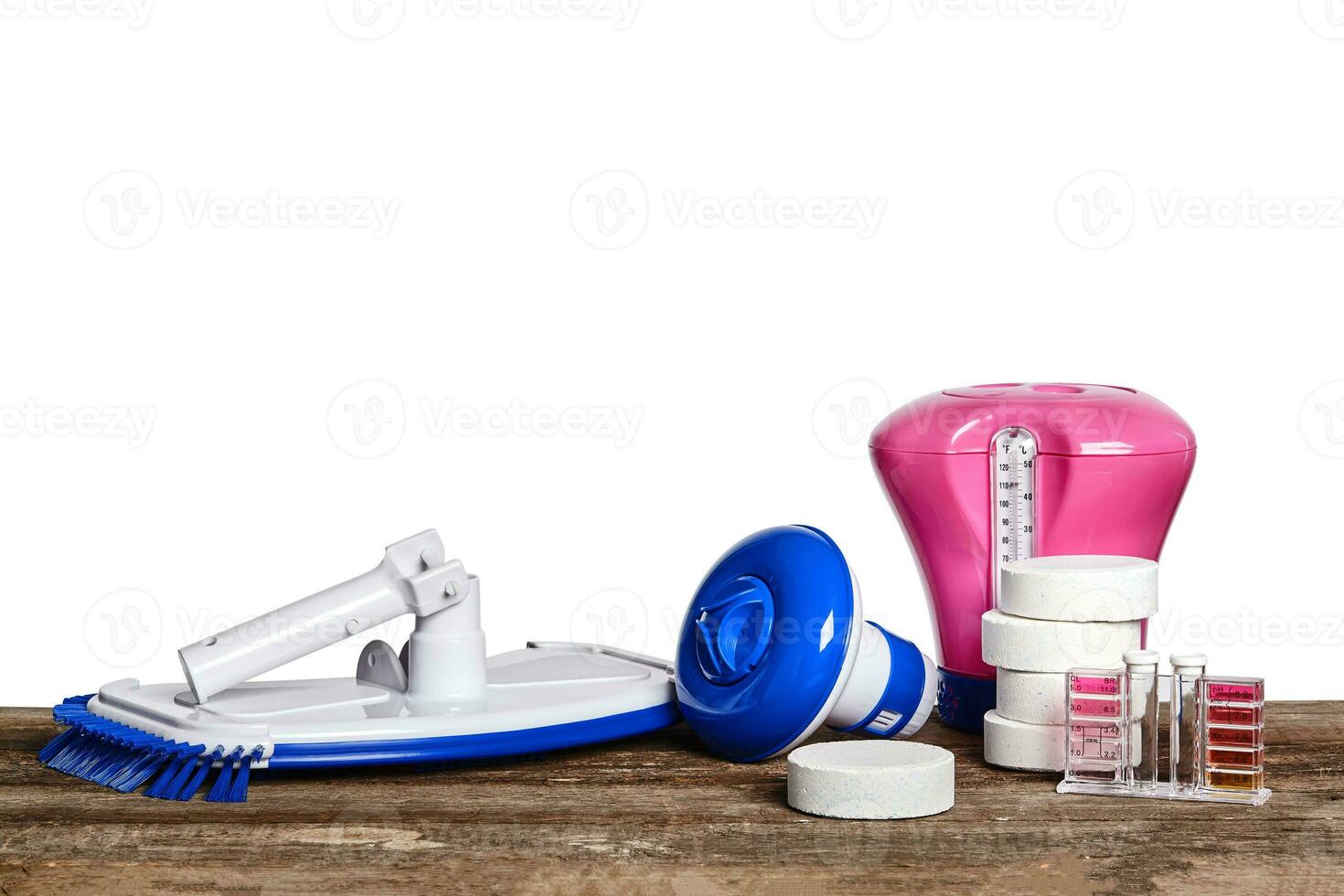 Equipment with chemical cleaning products and tools for the maintenance of the swimming pool on a wooden surface against white background. photo