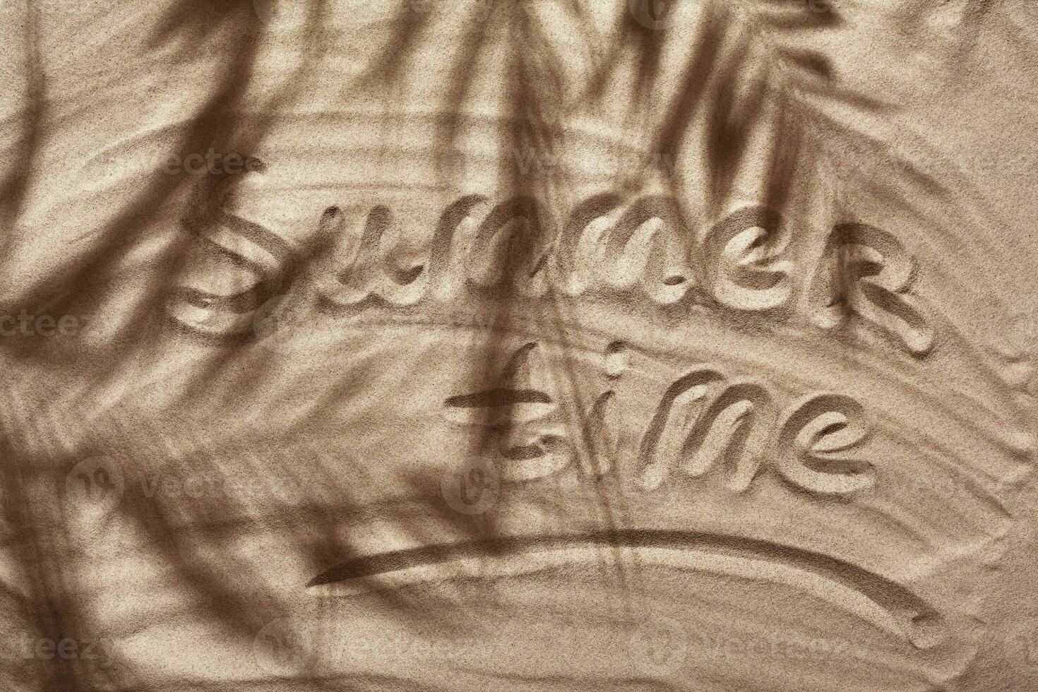 Summer concept with a shadow of a tropical palm tree leaves, copyspace on a white beach sand. photo