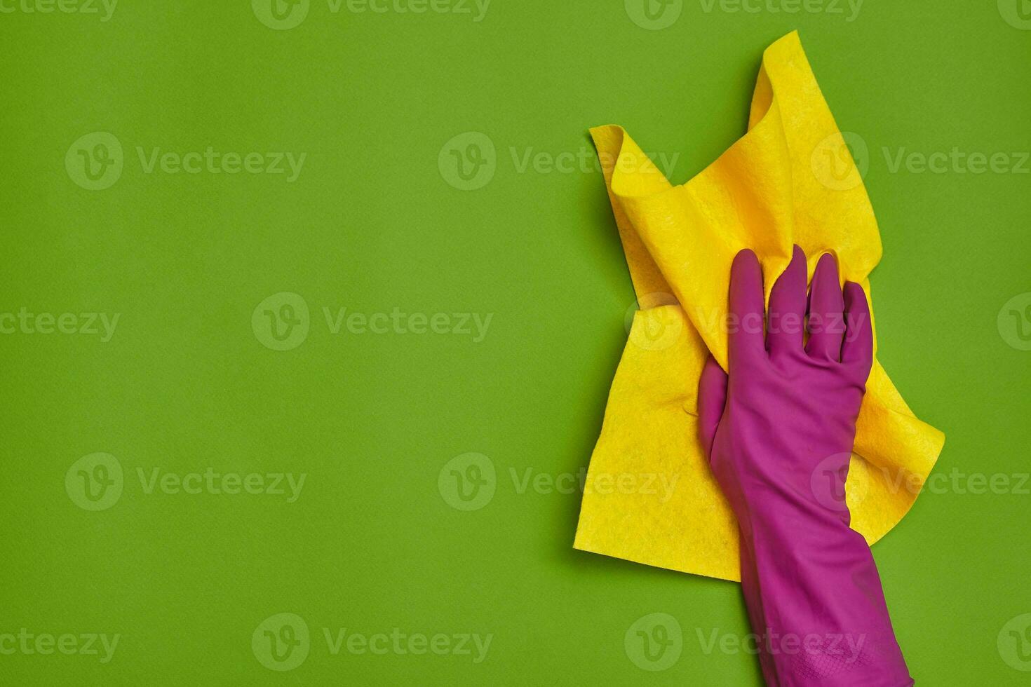 Detergents and cleaning accessories on a green background. Housekeeping concept. photo