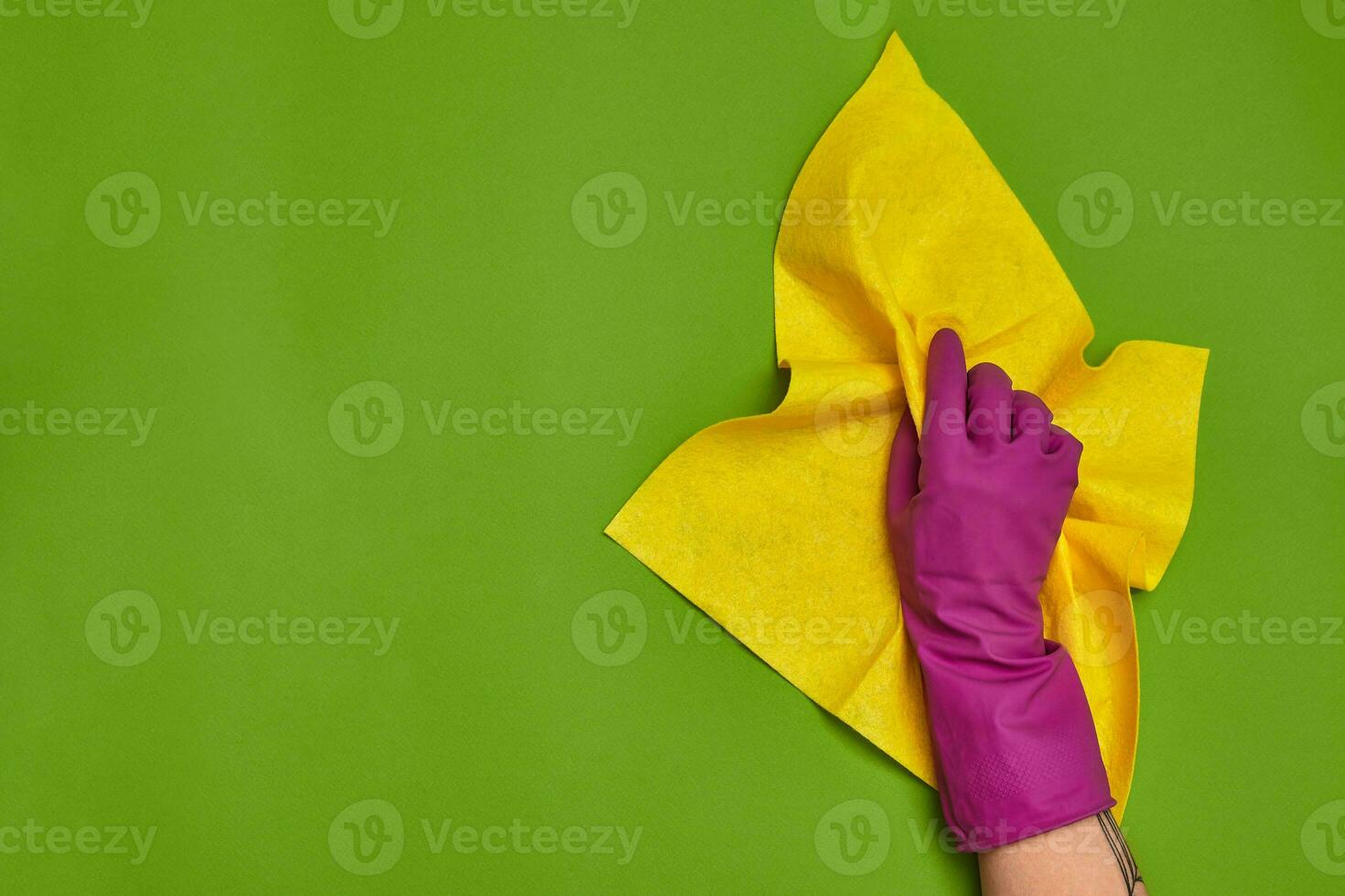 Detergents and cleaning accessories on a green background. Housekeeping concept. photo