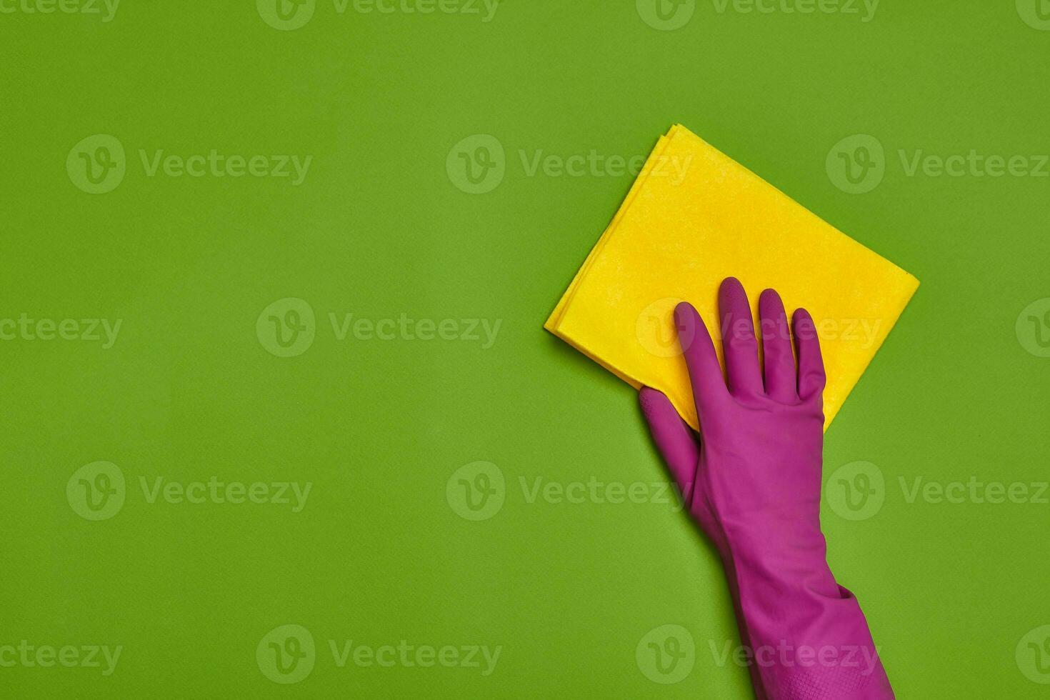 Detergents and cleaning accessories on a green background. Housekeeping concept. photo