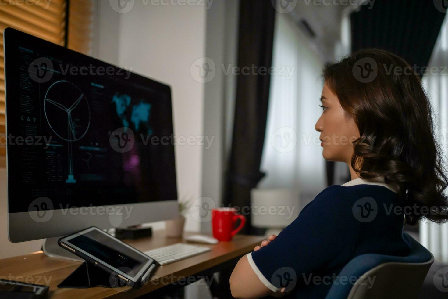 Futuristic women Engineer working with Holographic Augmented Reality and 3D Wind Turbine Model on computer and tablet at home office ,Concept of technology and environment photo