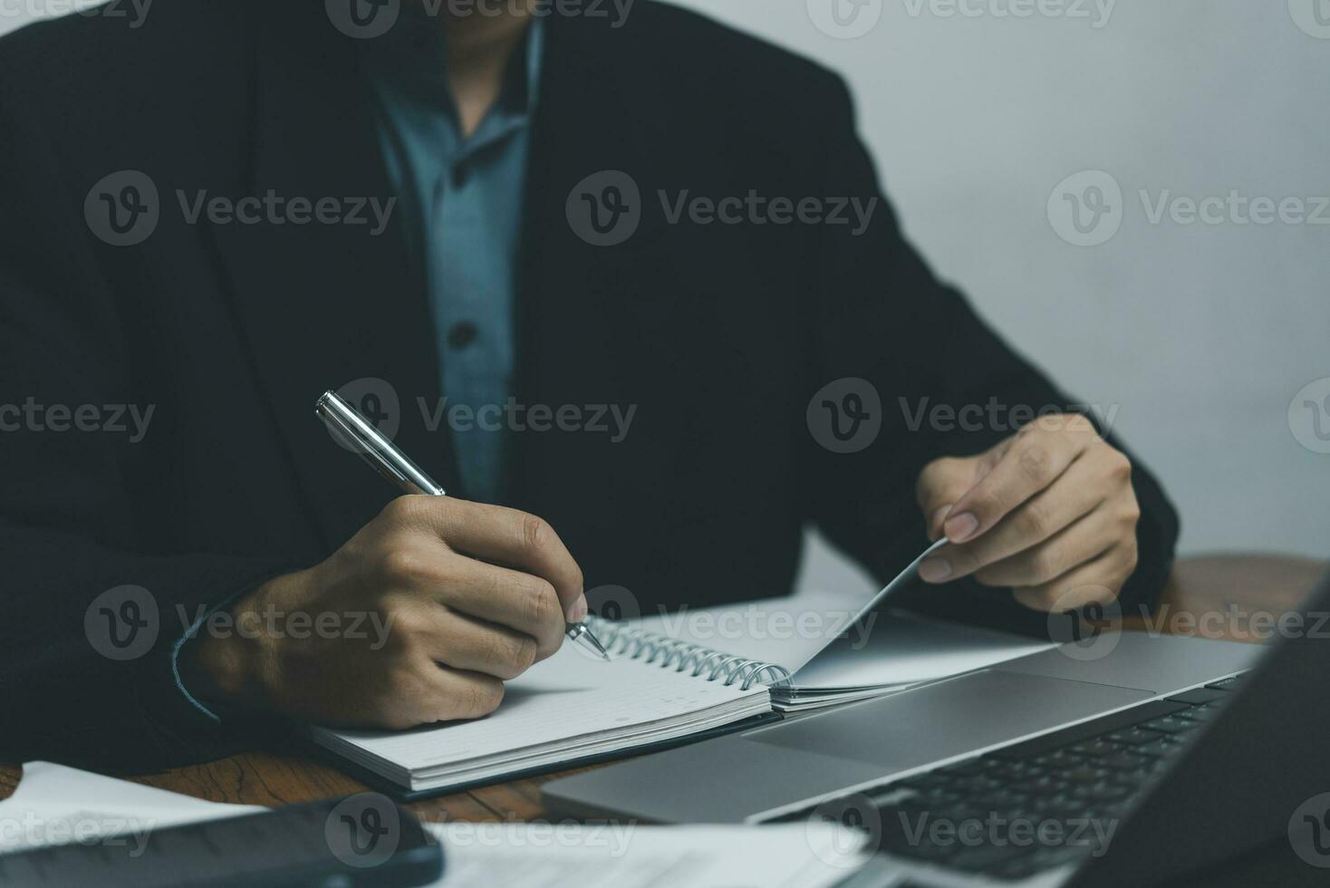 man hands with pen writing journal on notebook in the office.creativity inspiration learning, education and work.writes goals, plans, make to do and wish list on desk. photo