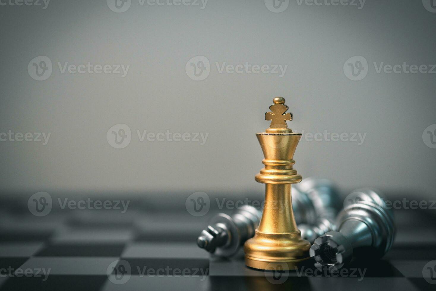 Gold king chess piece win over lying down pawn on black background