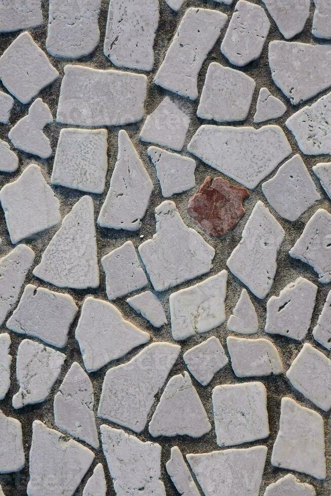 a stone floor with a red stone in the middle photo
