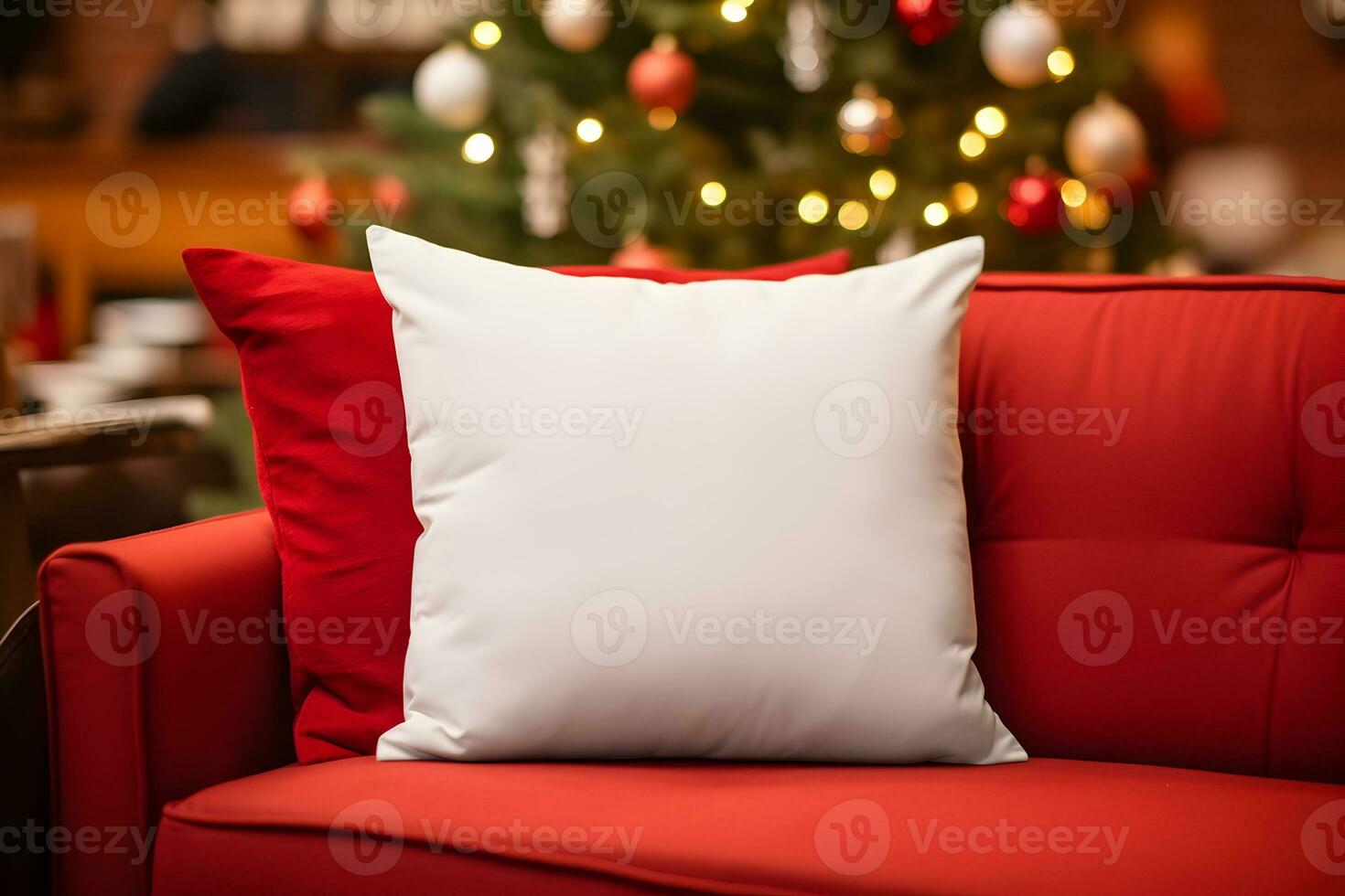 Blank white pillow mockup on red sofa with christmas tree and lights bokeh background. Holiday template composition with decoration. Copy space. photo