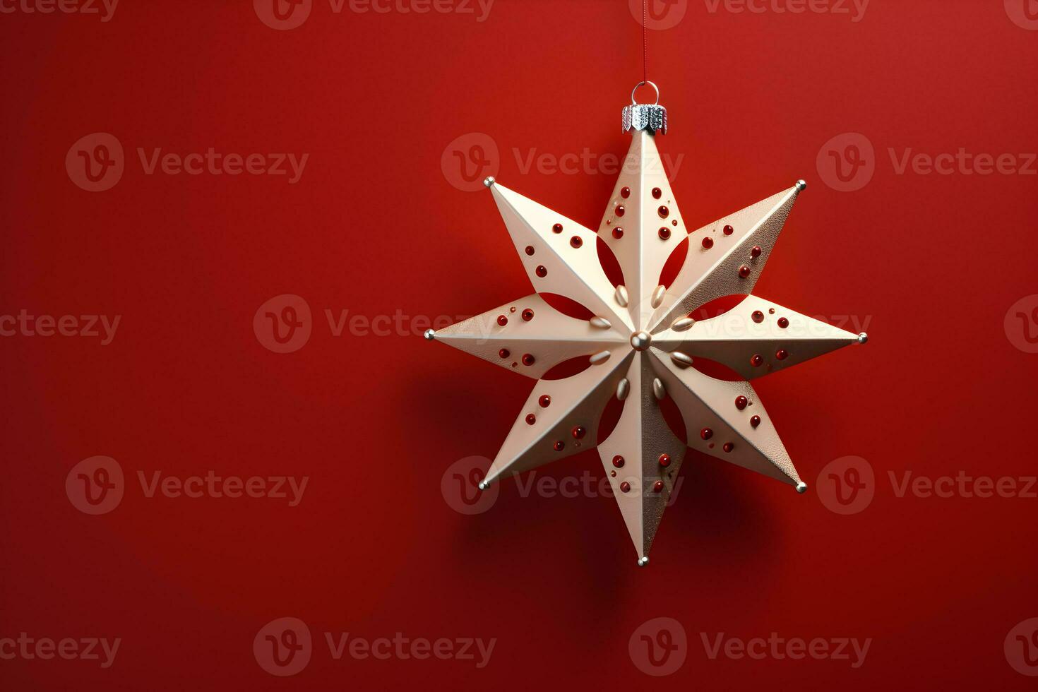 Christmas flat lay mockup with shining gold star decoration on red background with copy space. Top view of winter holiday concept composition. photo