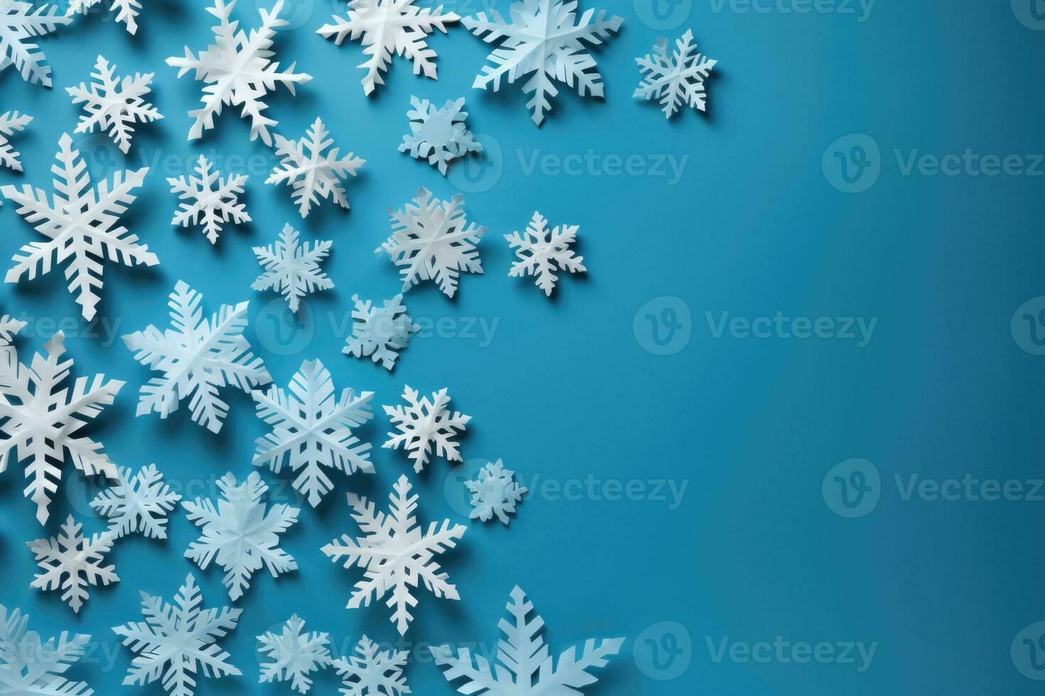 Creating DIY paper snowflakes scattered on crafting table background with empty space for text photo