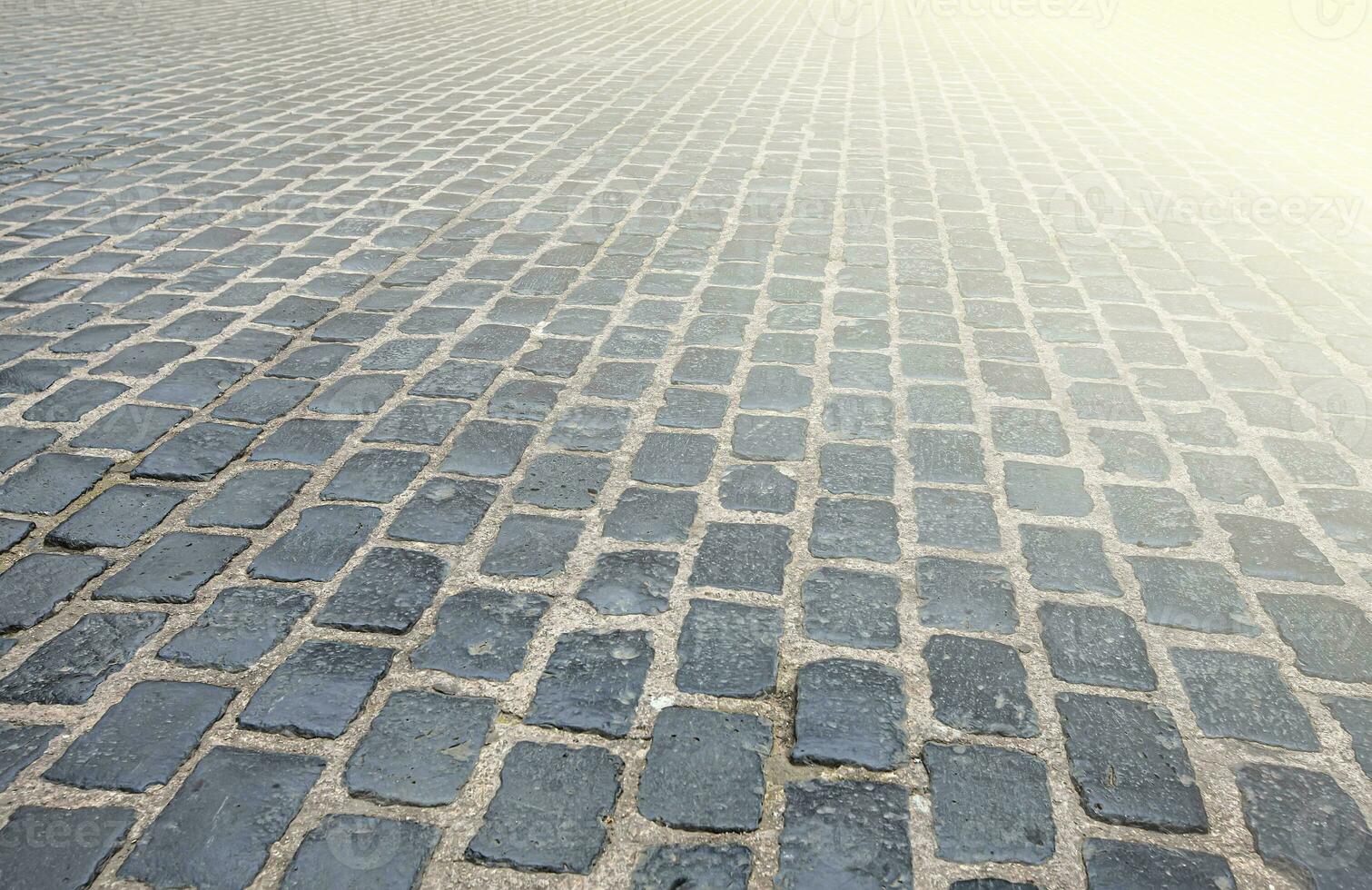 Surface is paved with road tiles of different sizes as texture photo
