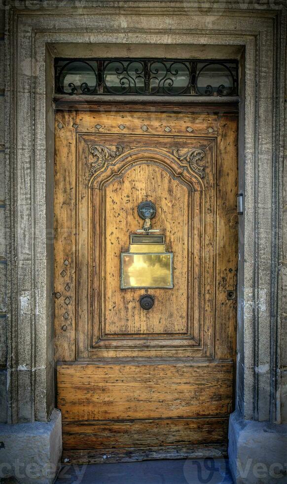 Old vintage wooden door with gilded metal plate photo