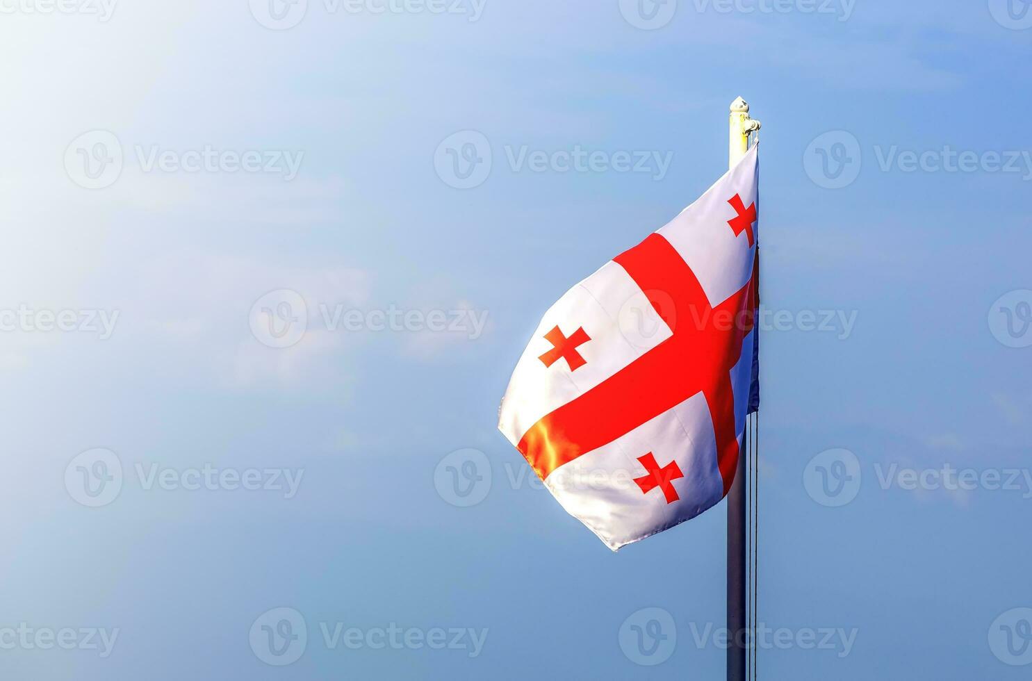 flag of georgia against the blue sky photo