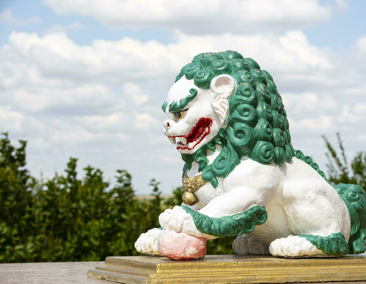 Sculpture of a lion guarding the entrance to the Buddhist temple of the Syakyusn sume photo