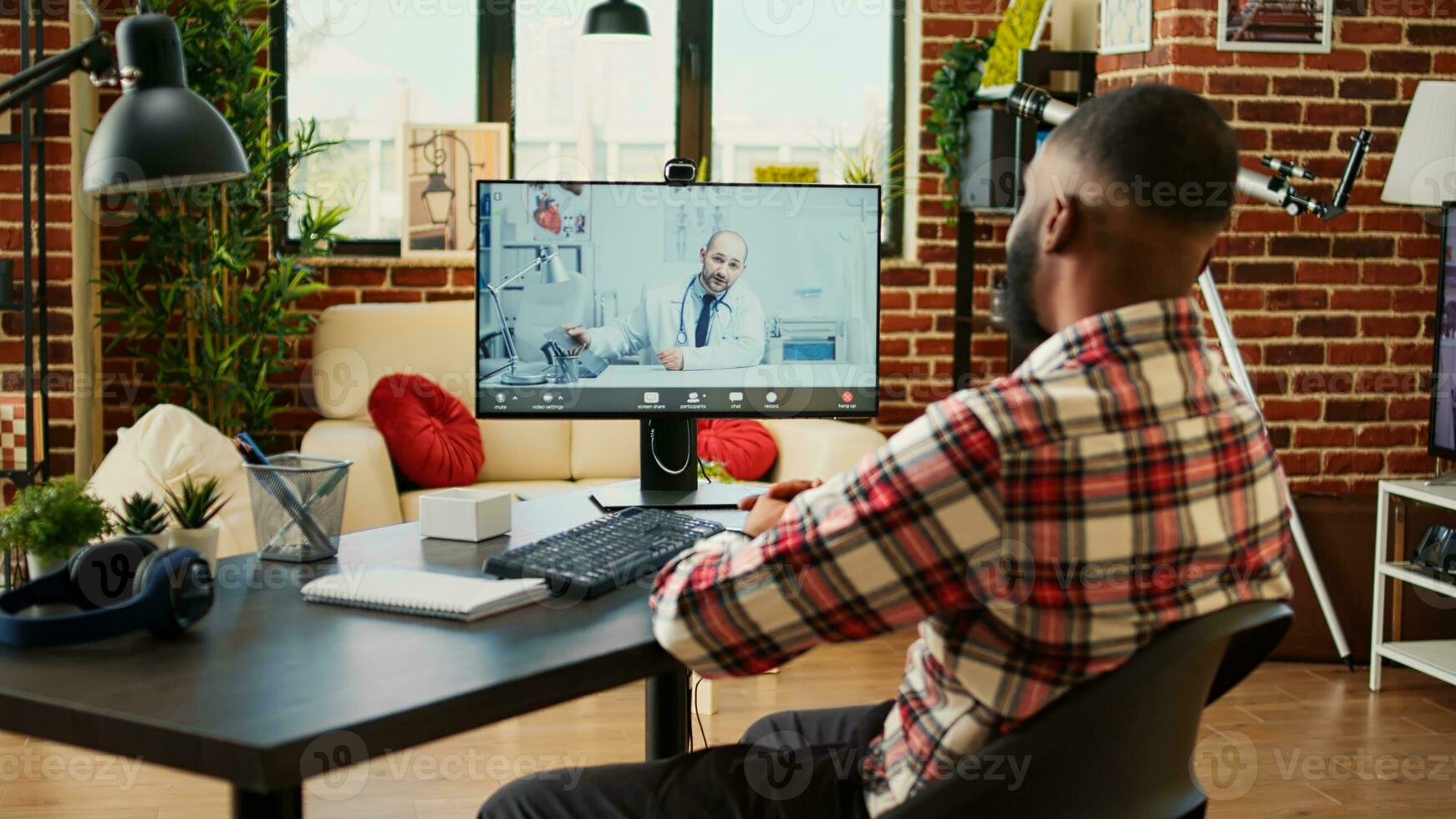 Remotely working employee in telemedicine video call asking for medical advice. Teleworker in online consultation with doctor, doing checkup after staying home for too long photo