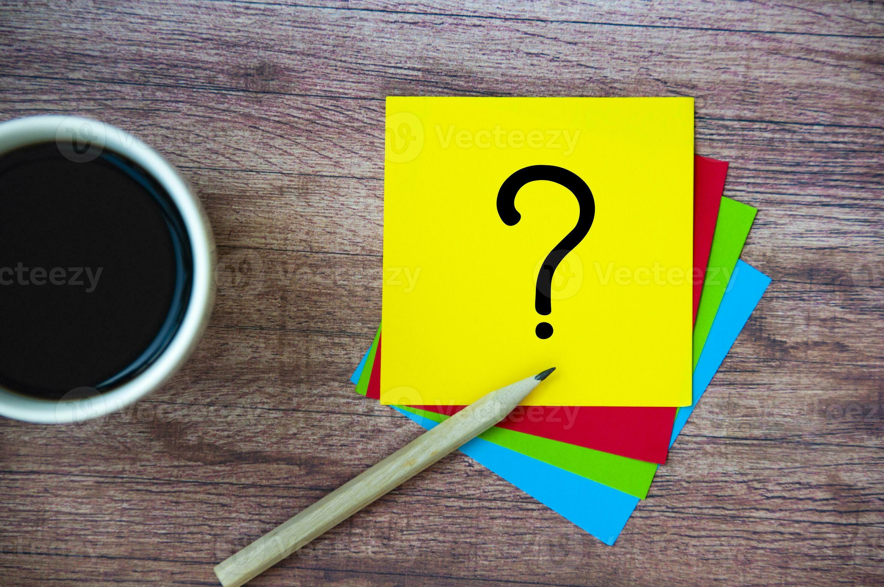 Top view of question mark on notepad. Question and answer concept