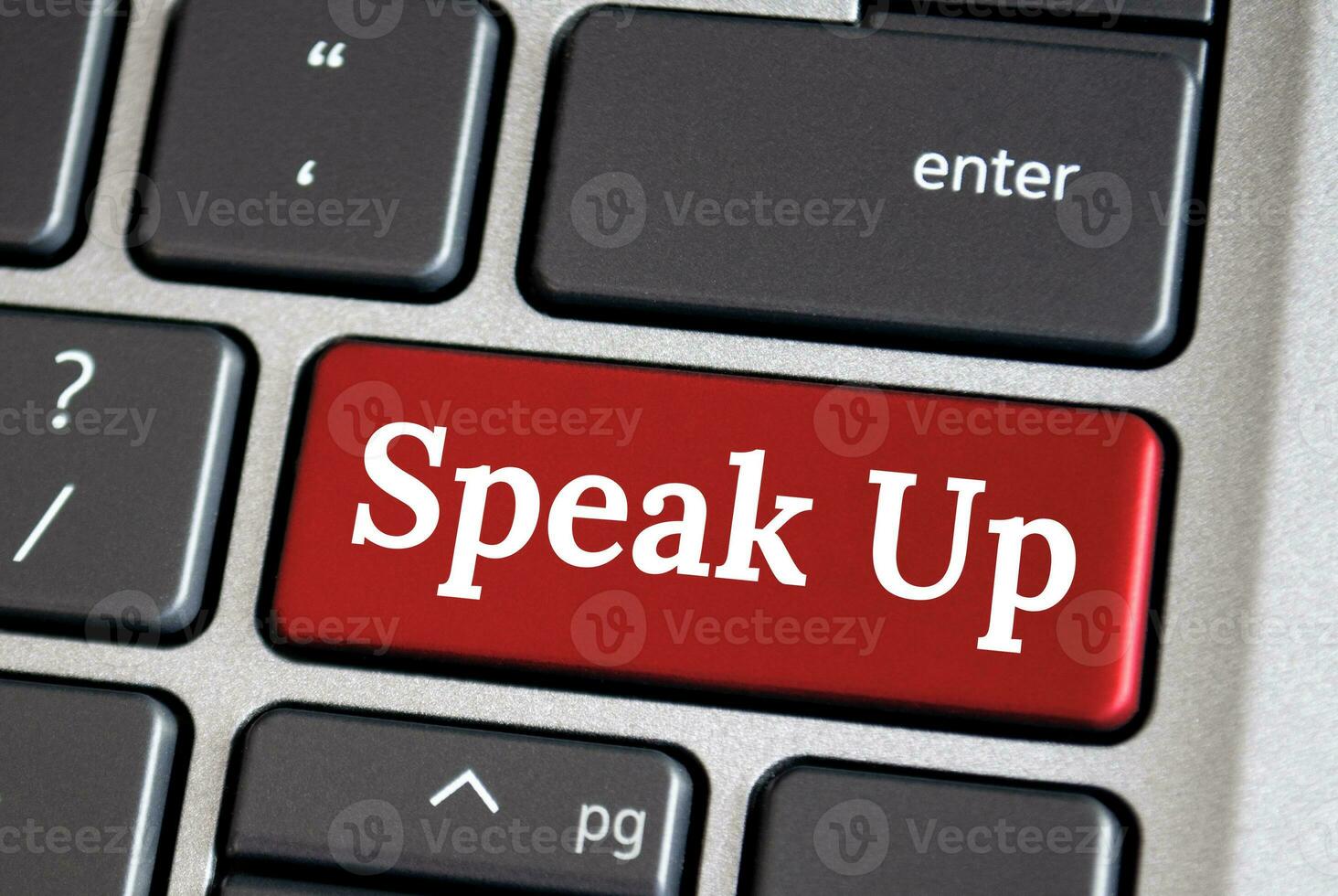 Speak up text on red color laptop keyboard. Courage to speak up concept. photo