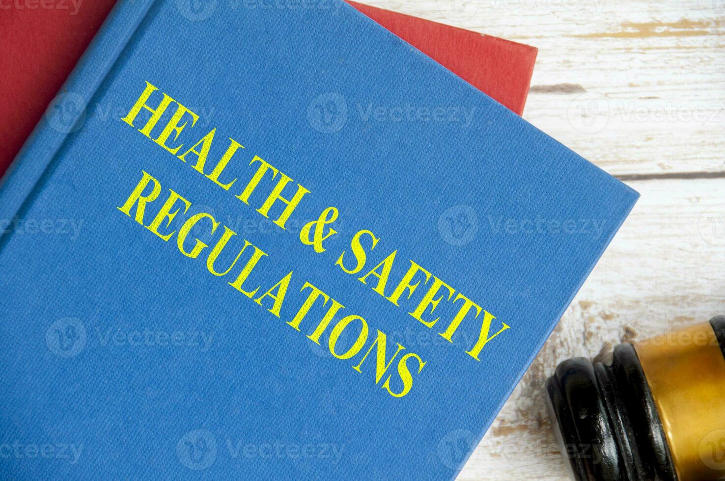 Top view of Health and Safety Regulations on blue book with gavel background. Law concept photo