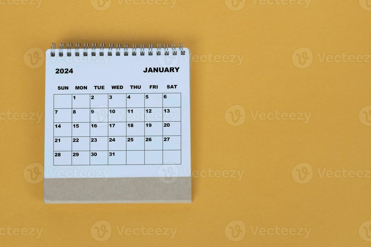January 2024 desk calendar on yellow background. Directly above. Flat lay. photo