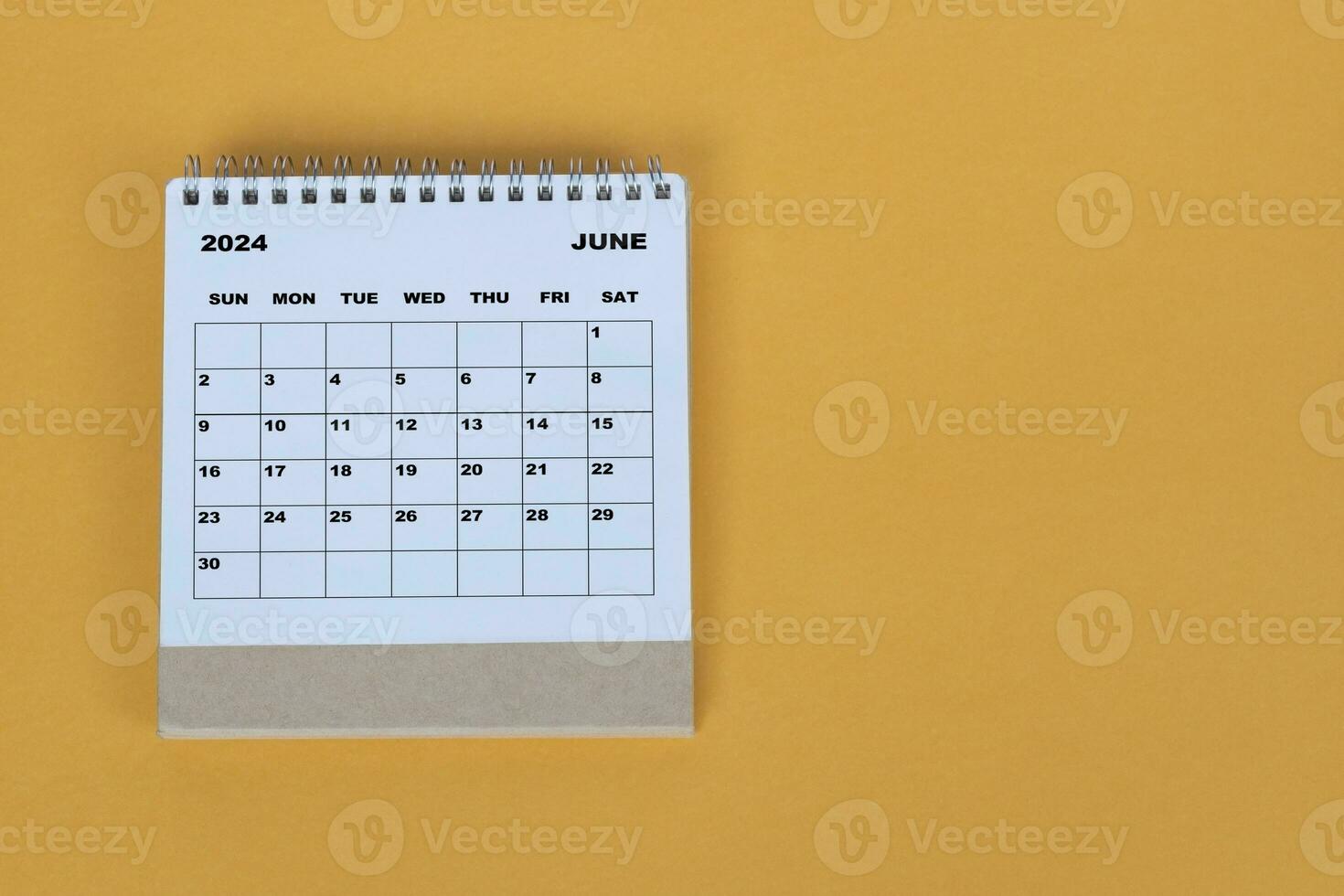 June 2024 desk calendar on yellow background. Directly above. Flat lay. photo
