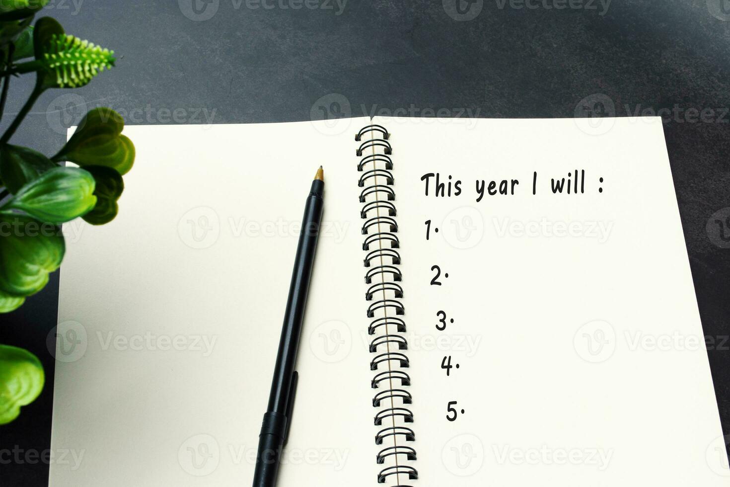 This year i will list on notepad. New year goals concept. photo