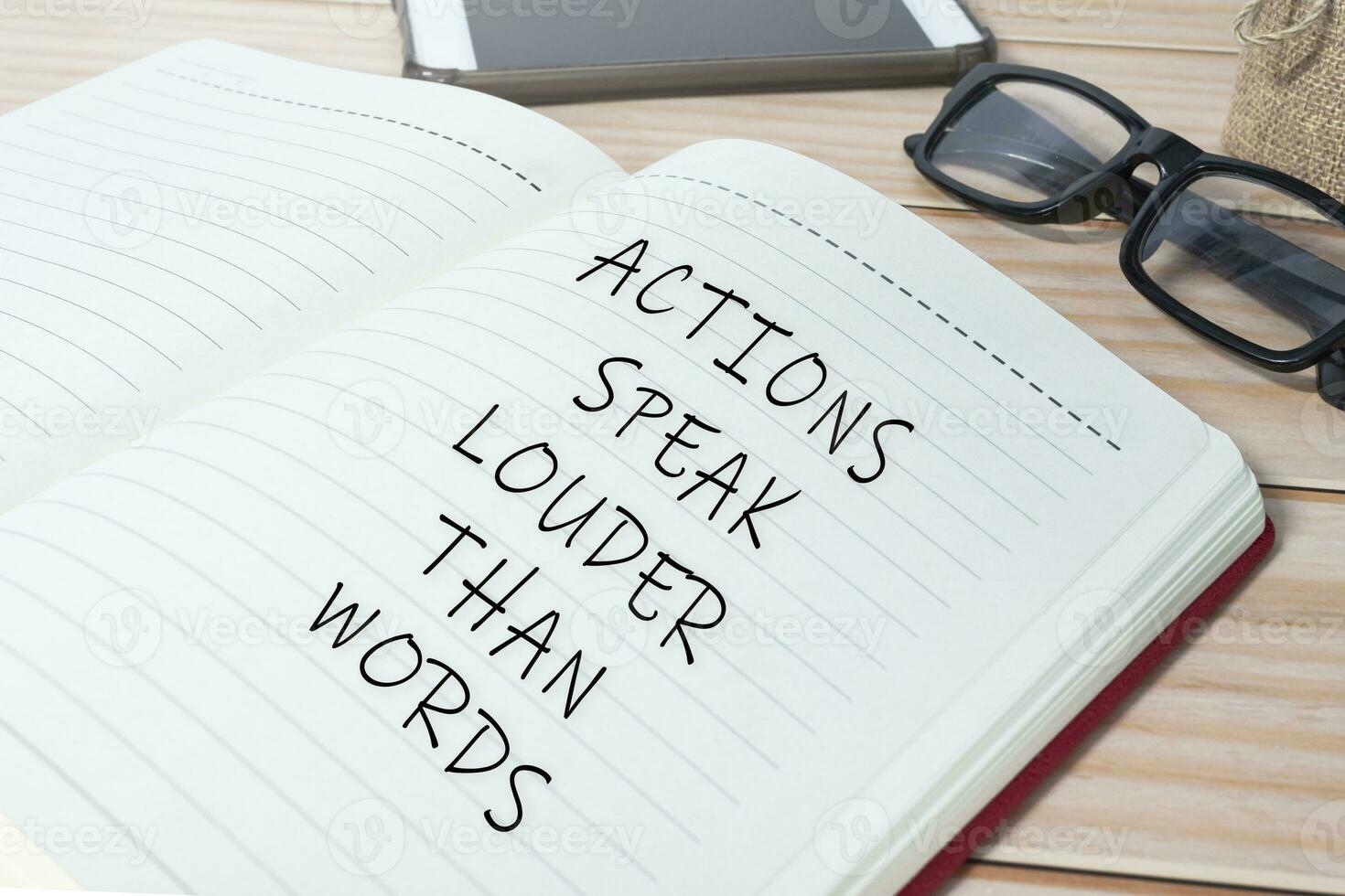 Actions speak louder than words text on notepad. Business concept. photo