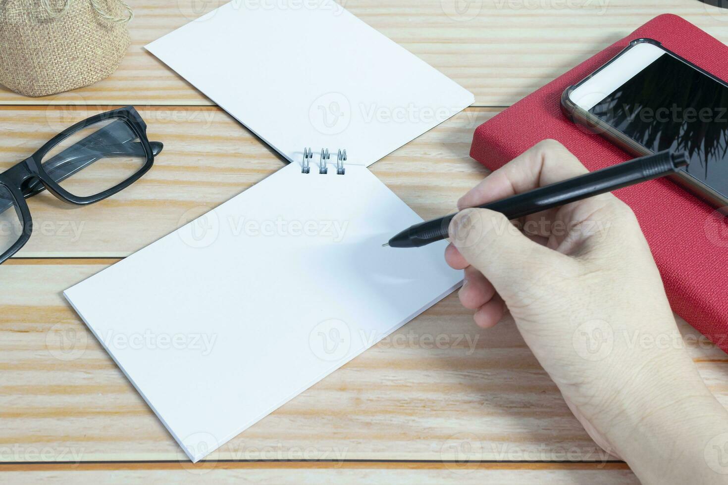 Businessman hands with pen writing notebook on office desk. Copy space. photo