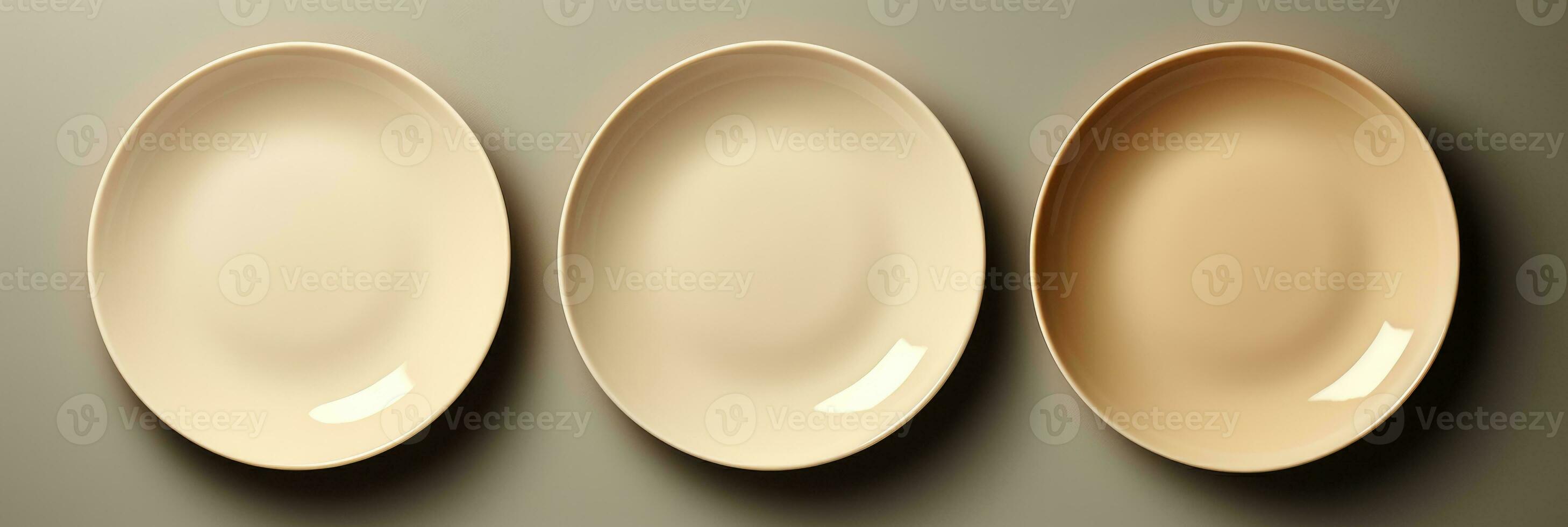 A chic set of minimalistic porcelain dining plates isolated on a taupe gradient background photo