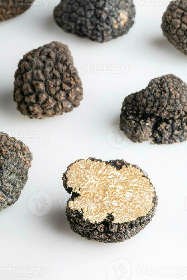 Macro shot of black truffle mushroom full and cut isolated on white background photo