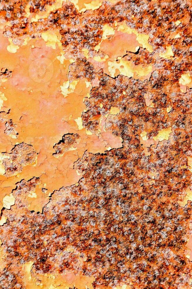 rusty metal surface with orange paint photo