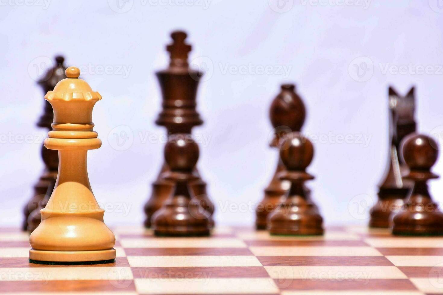 a chess piece is standing in front of a group of chess pieces photo