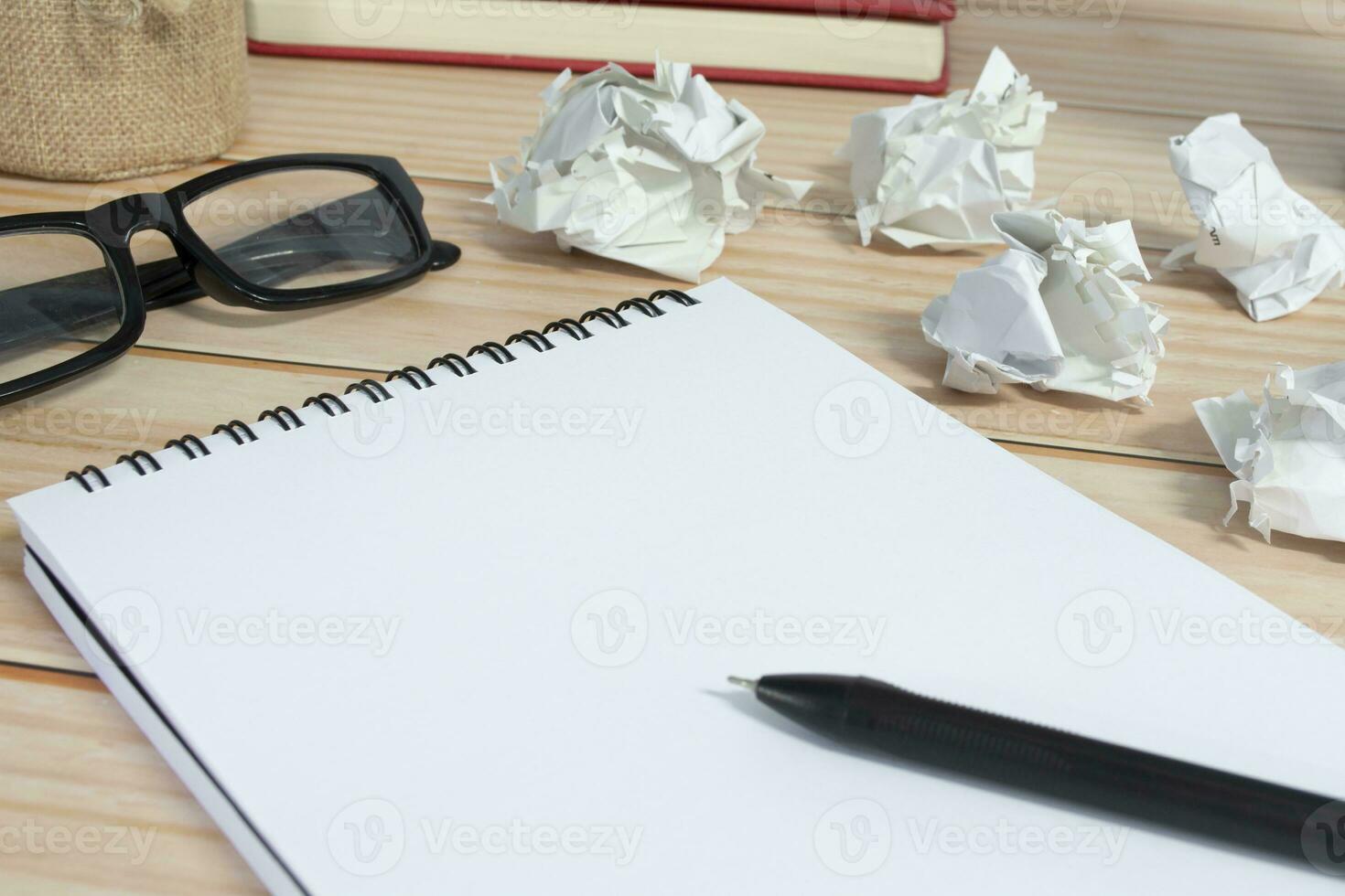 Notepad with trash paper background on office desk. Copy space. photo
