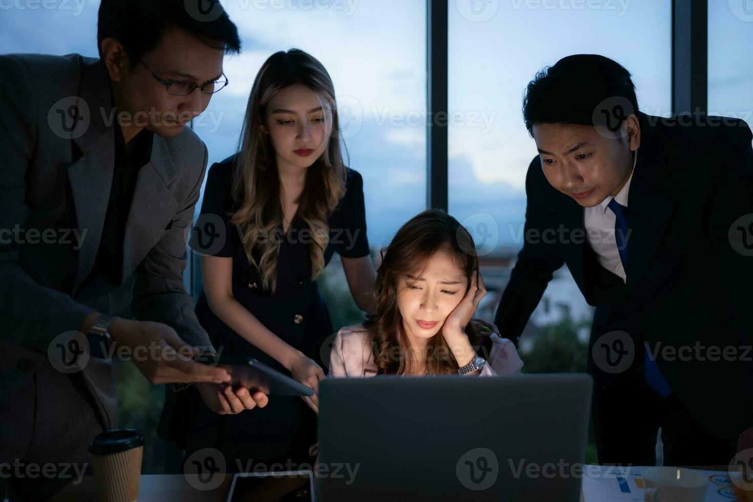 Group of broker international stock traders working actively at night in office, A young woman is working hustle to present a client with friends helping her with information. photo