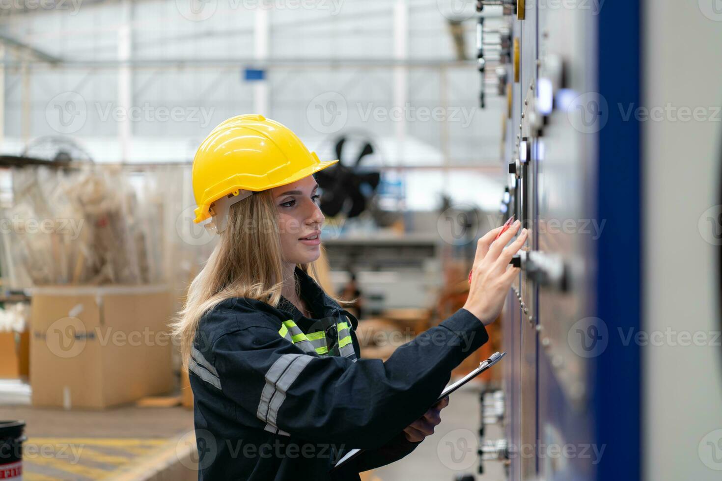 Female engineers check the operation of the machine's circuit board. photo