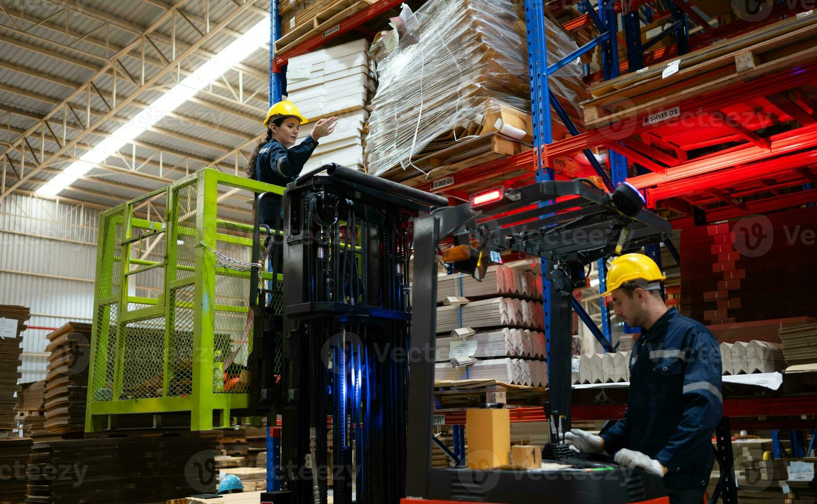 Warehouse workers using forklift to check and counting in a large warehouse. This is a large paper package storage and distribution warehouse. photo