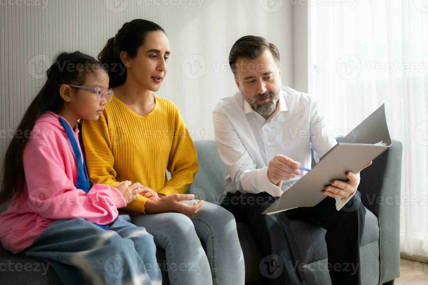 Psychotherapist working with child patient and mother in office, Concept of psychotherapy photo