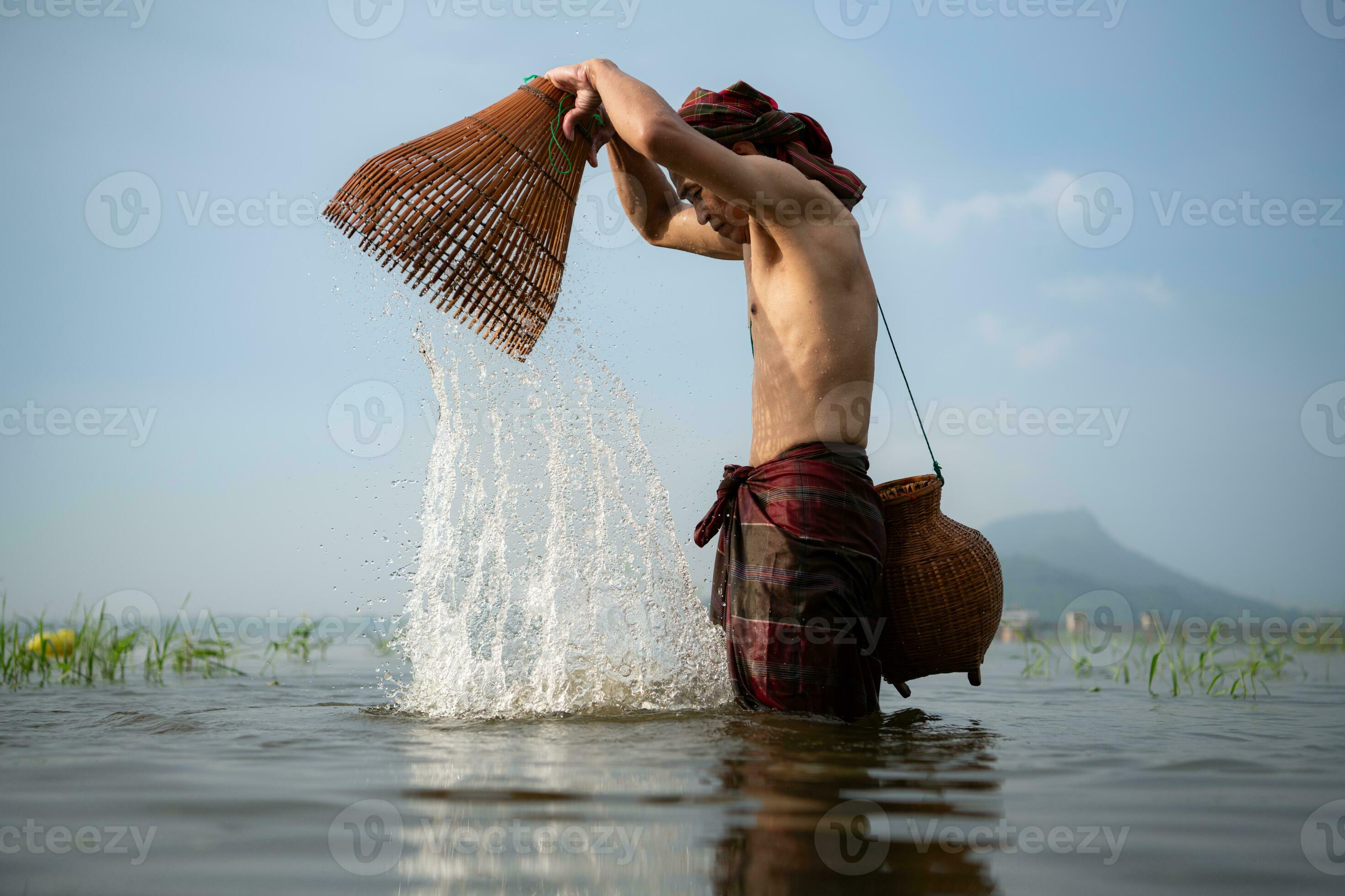 Fisherman using traditional fishing gear to catch fish for cooking, Rural  Thailand living life concept 34344056 Stock Photo at Vecteezy