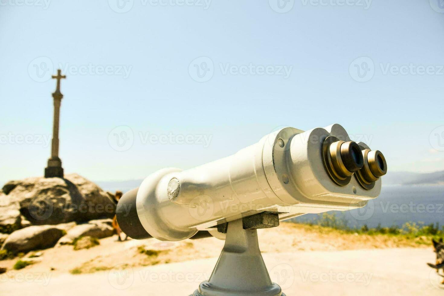 a telescope is on a hill overlooking the ocean photo
