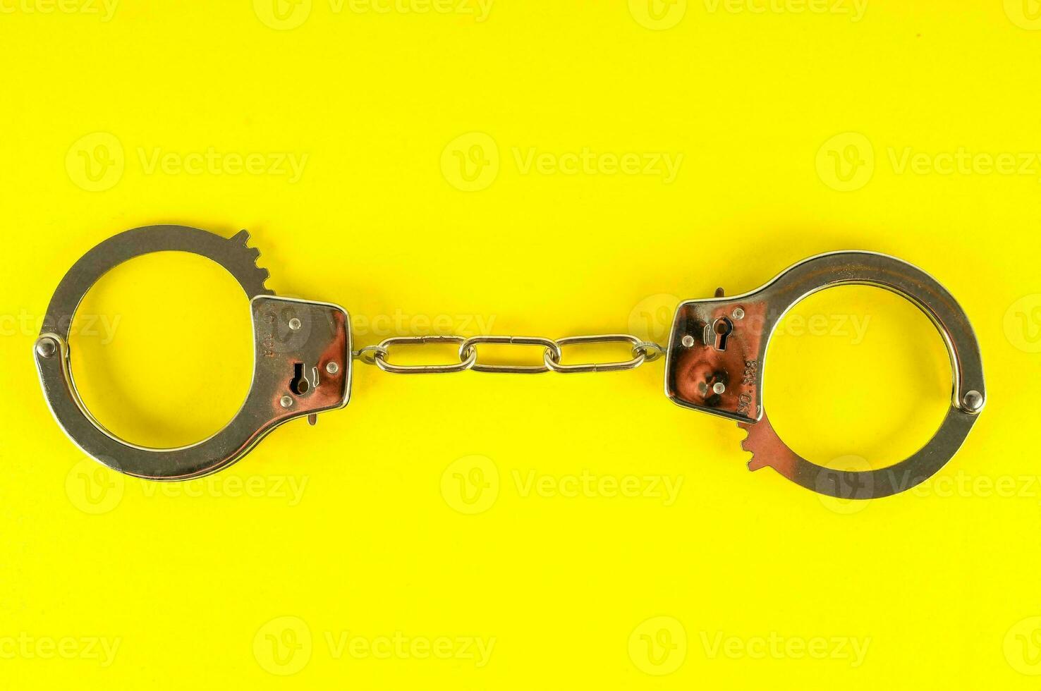 handcuffs on a yellow background photo