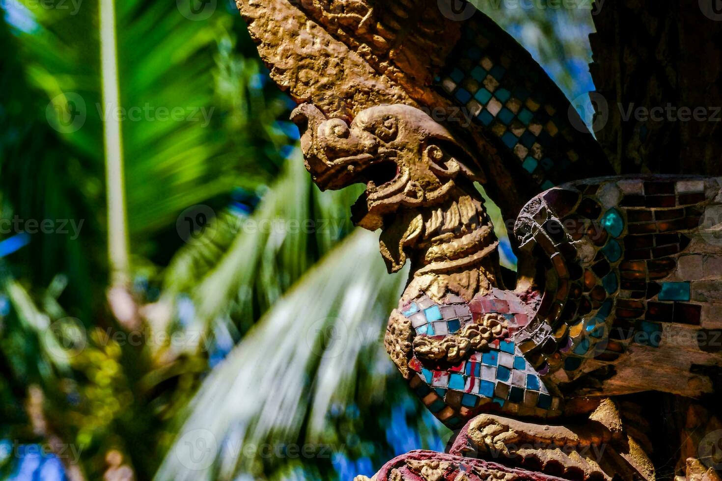 a statue of an eagle on a tree photo