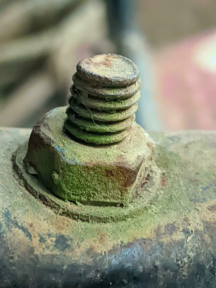 Rusty bolt on a metal surface, closeup macro. photo