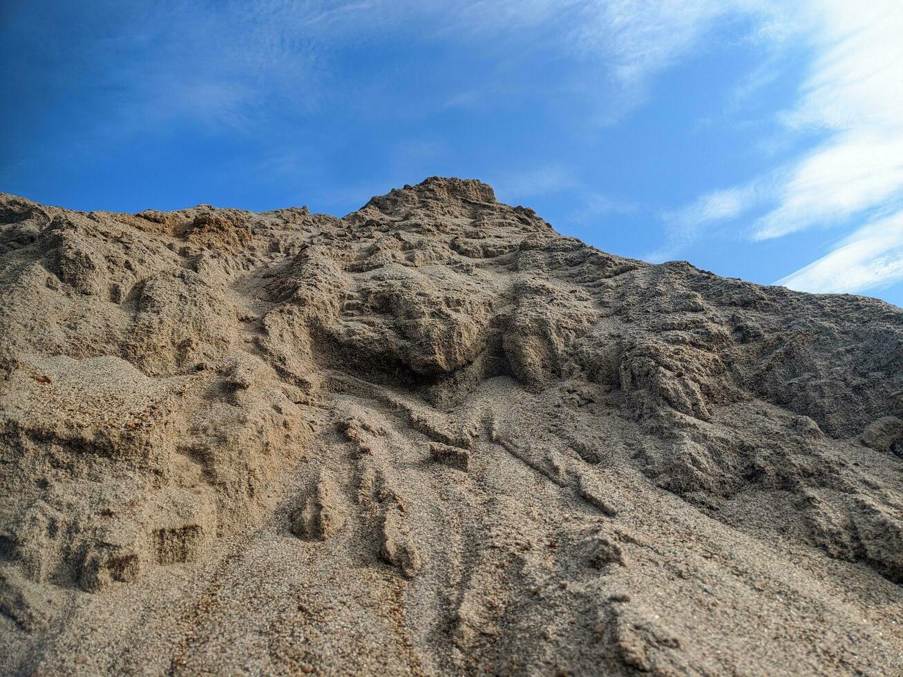 Sand on the beach with blue sky in the background. photo