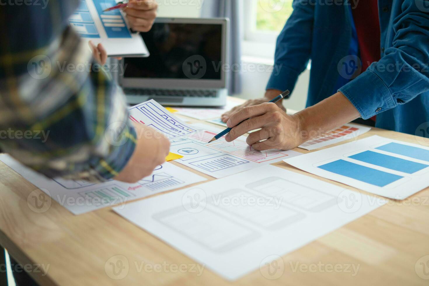 The designer team is designing the uxui system to make the uxui system work well on new phones and support system updates. Website development concept UI UX front end designer photo