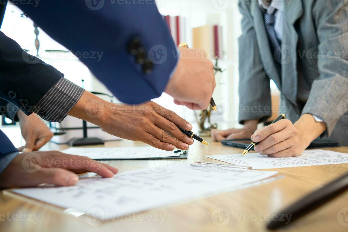 Businessmen and investors sign contract in front of company legal advisor and witness contract for their real estate investment. signing contract between businessman and an investor in front of lawyer photo