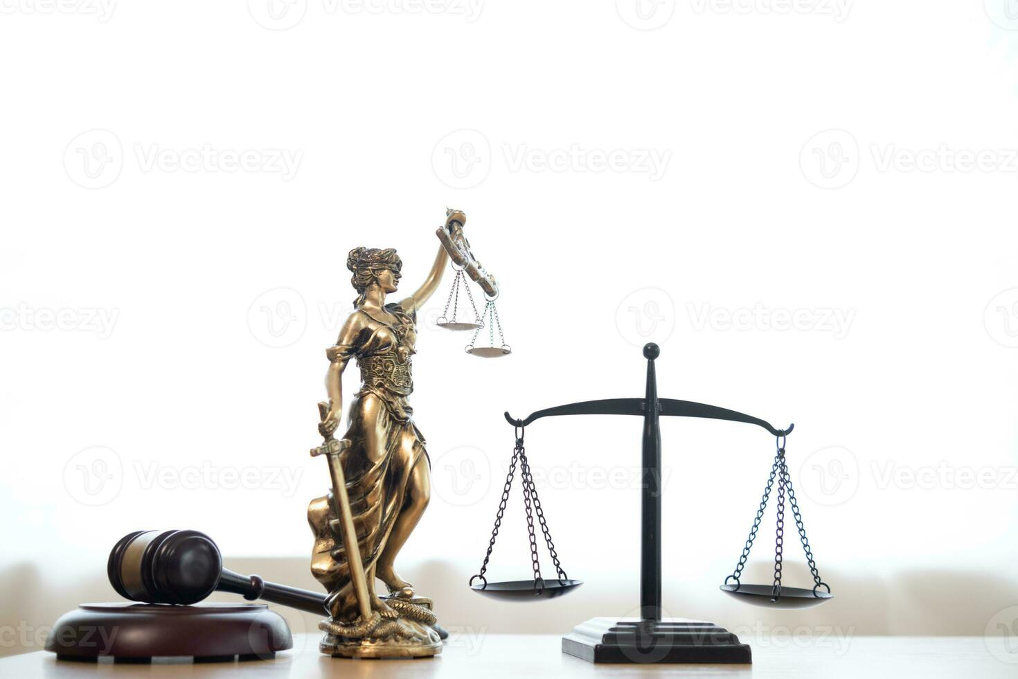 gavel wood Brass scales and a statue of Themis Lady Justice are placed on the tables of the lawyers in the legal counsel's office as a symbol of justice. Concept building trust with symbols of justice photo