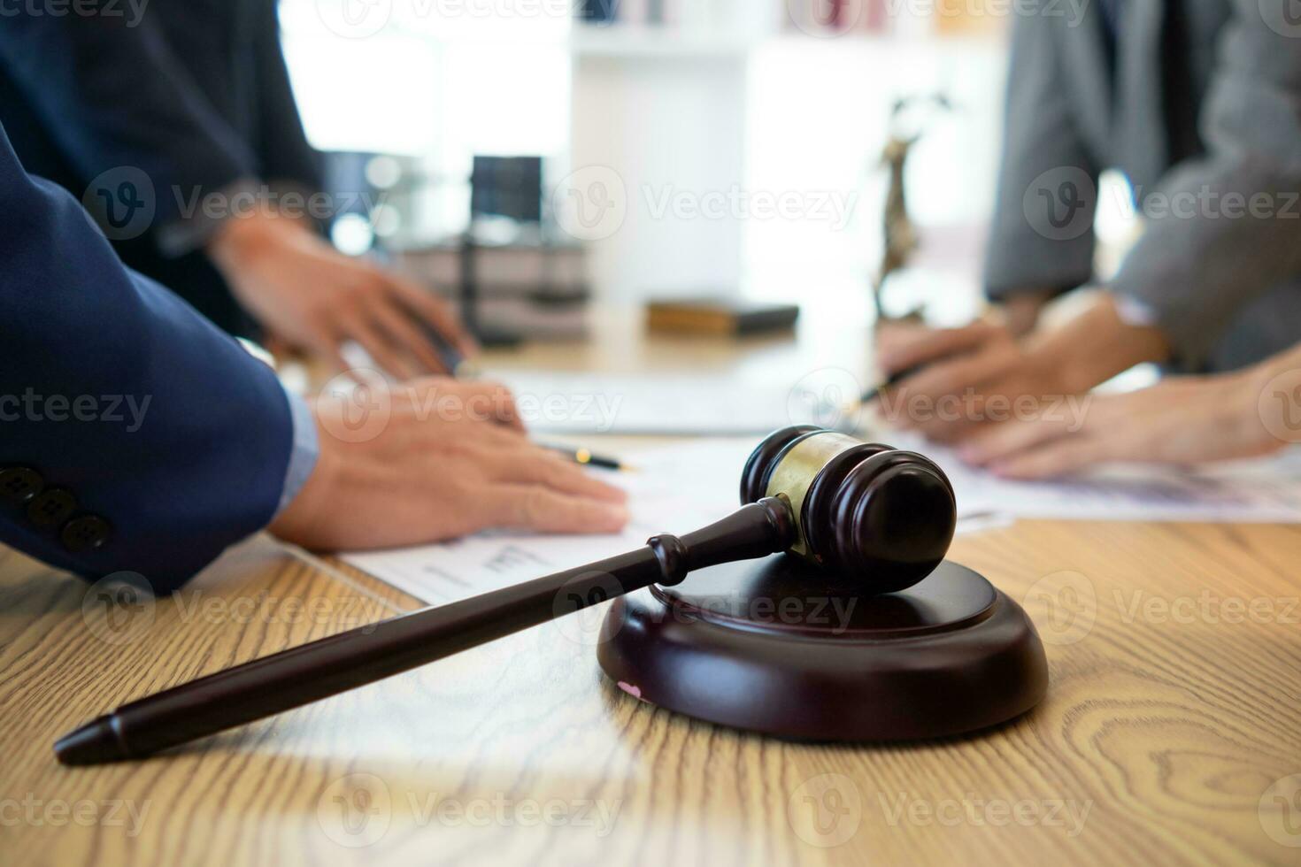 judge's gavel in law office is placed on table to symbolize judge deciding lawsuit. gavel wood on wooden table of lawyers in legal advice office as symbol of fair judgment in cases. photo