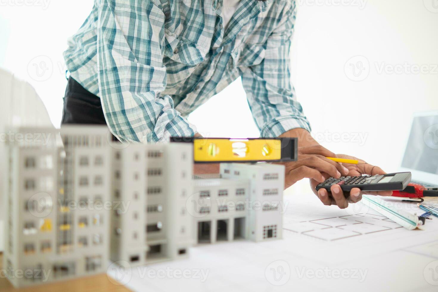 Construction engineers are checking blueprints and calculating their accuracy after receiving plans from architect in order start  construction safely. Inspection Concept from construction engineering photo