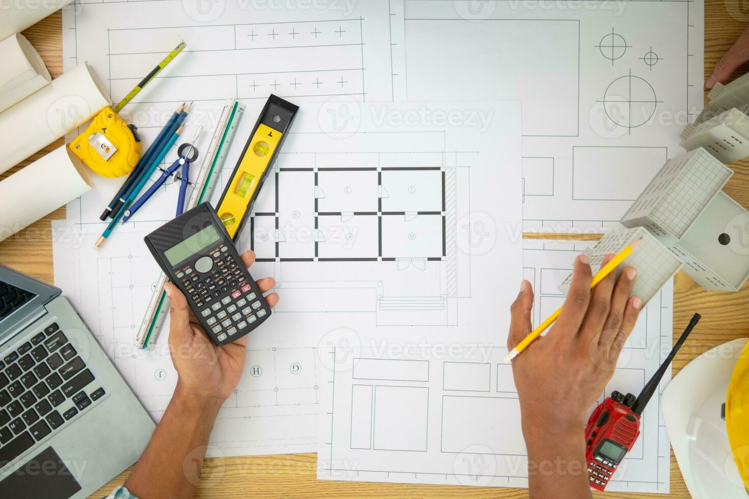 Construction engineers are checking blueprints and calculating their accuracy after receiving plans from architect in order start  construction safely. Inspection Concept from construction engineering photo