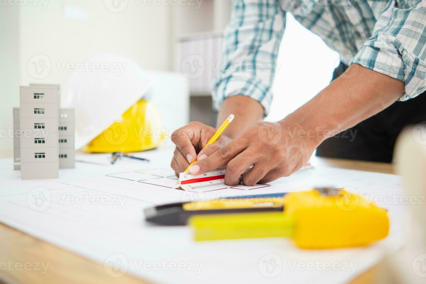Construction engineers are checking blueprints and calculating their accuracy after receiving plans from architect in order start  construction safely. Inspection Concept from construction engineering photo