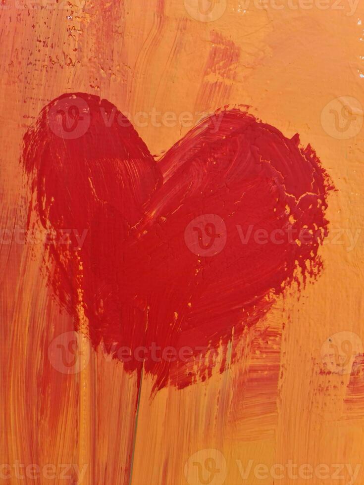 The red heart is painted with oil paint on the wall. photo