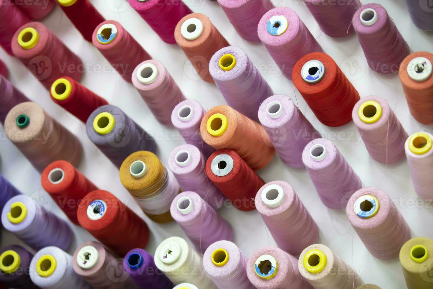 Spools of thread in various colors for the sewing studio. photo